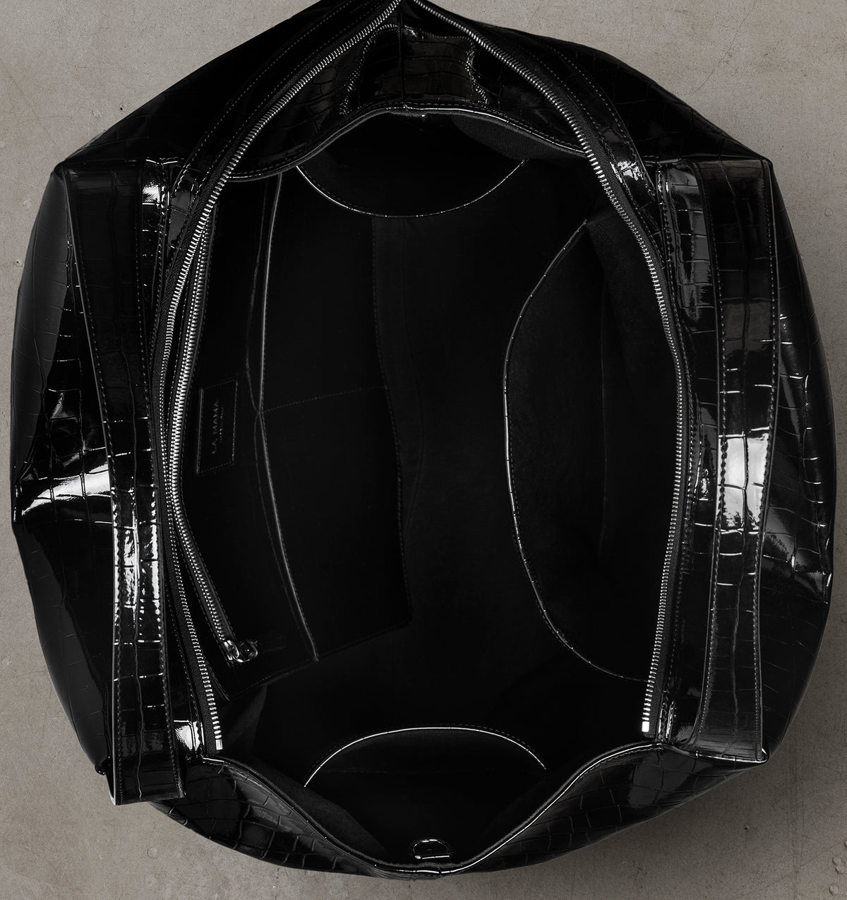 Interior view of the LA MAMA LM1 Black Lacquer Croco handbag with canvas lining.