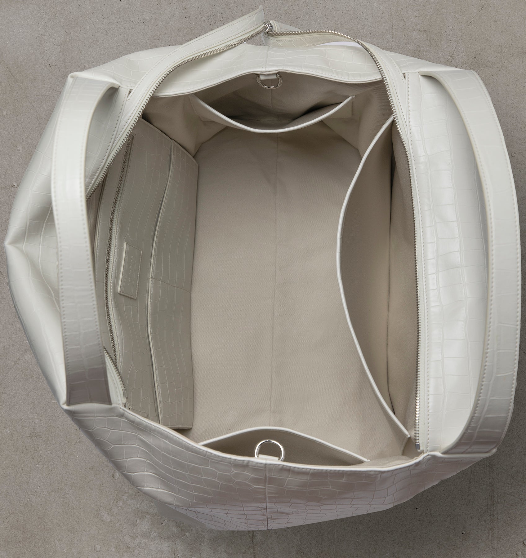 Interior view of the LA MAMA LM1 White Matte Croco handbag with canvas lining.