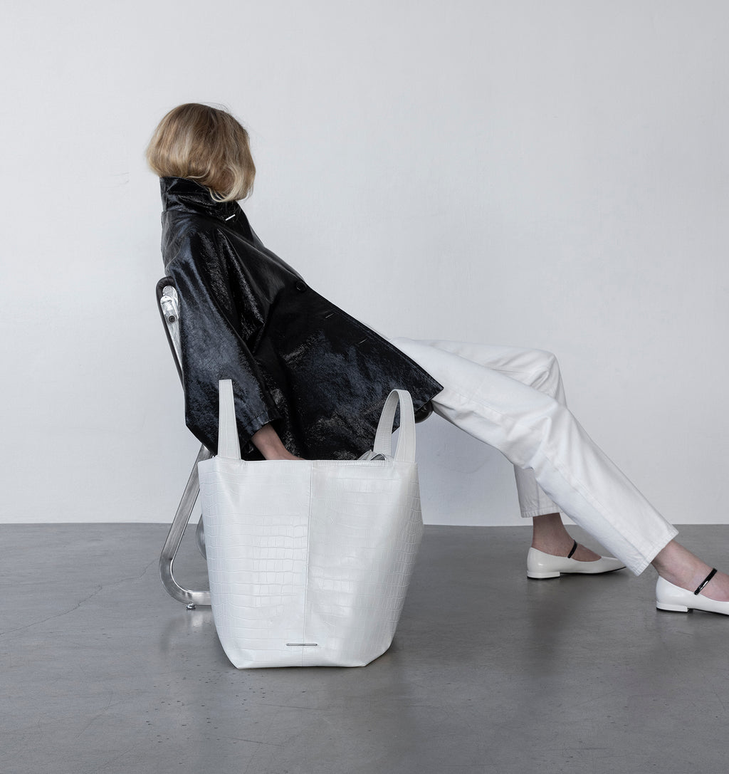 Model with the LA MAMA LM1 handbag in White Matte Croco on the floor.