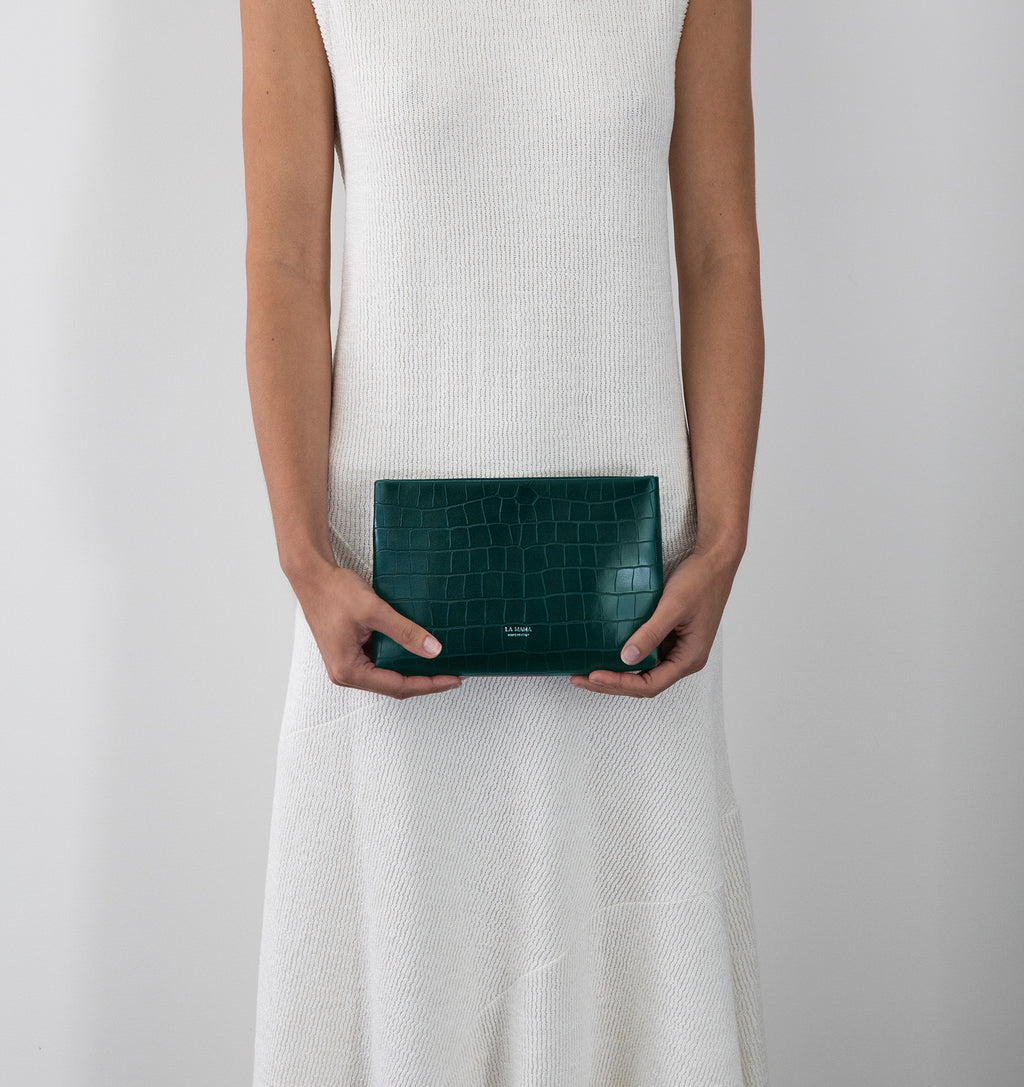 Model carrying the Small Pouch in Green Matte Croco in hand.