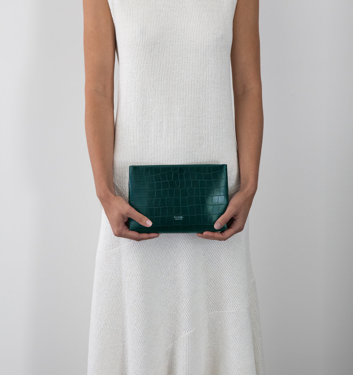 Model carrying the Small Pouch in Green Matte Croco in hand.
