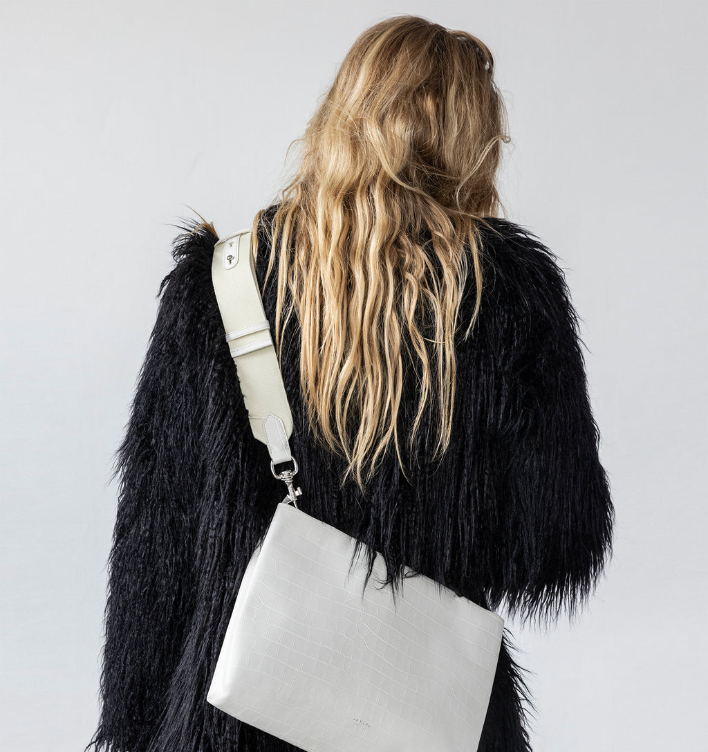 Model wearing the Large Pouch in White Matte Croco crossbody with the Tracolla.